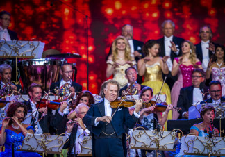 Andre plays violin. His orchestra make up the background