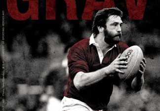Ray Gravell, in rugby kit, runs with a rugby ball